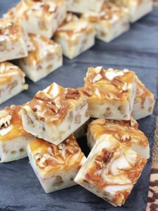 Creamy white chocolate fudge with crunchy pecans and a caramel swirl, perfect for holidays or any special occasion.