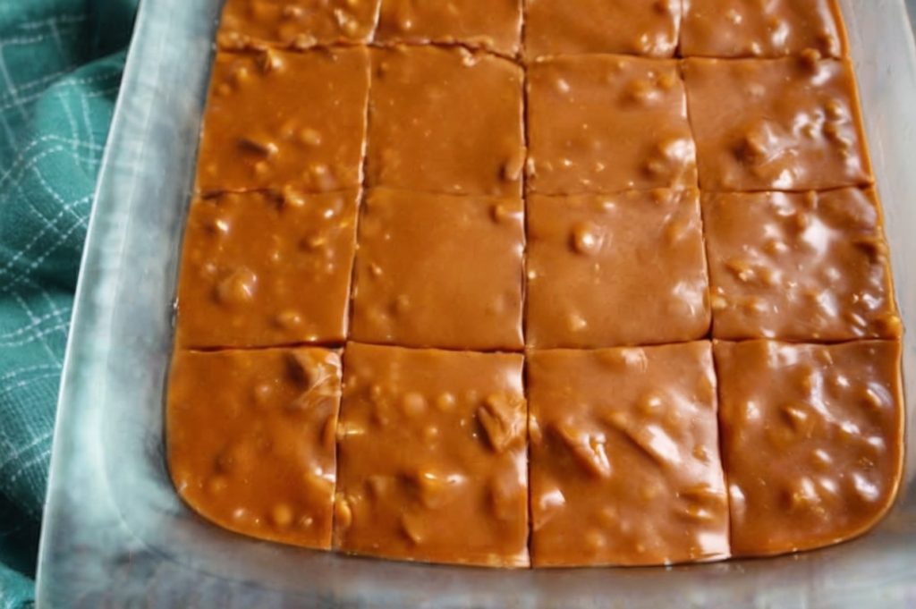 rectangular glass dish containing a batch of homemade caramel fudge