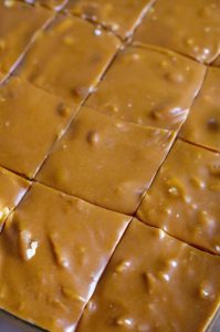 rectangular glass dish containing a batch of homemade caramel fudge