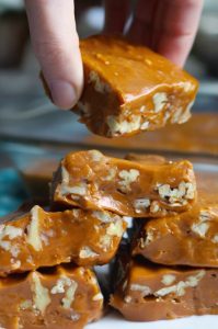 rectangular glass dish containing a batch of homemade caramel fudge