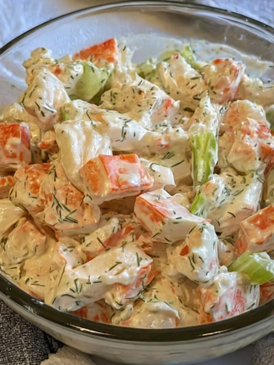 A creamy and refreshing seafood salad with imitation crab, celery, and a tangy dill dressing, perfect for summer gatherings or light lunches.