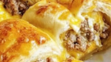 Flaky crescent rolls filled with savory sausage and gooey cheese, perfect for breakfast or snacks.